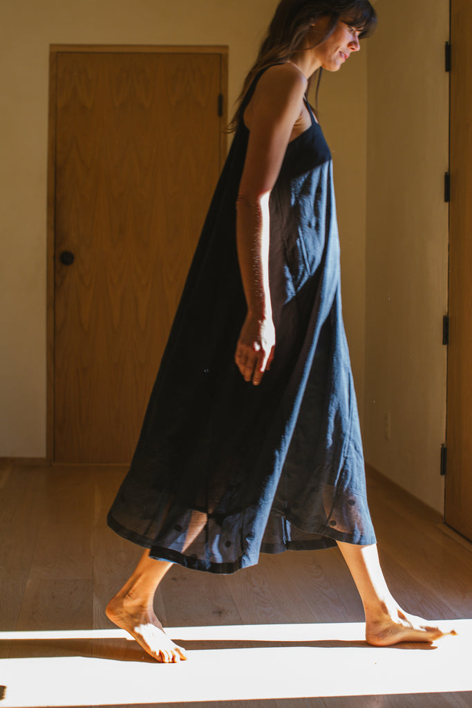 This Everywhere dress is made in collaboration between Erica Kim and World of Crow, it's sleeveless, black in color, Jamdani fabric, Midi length, Sustainably made