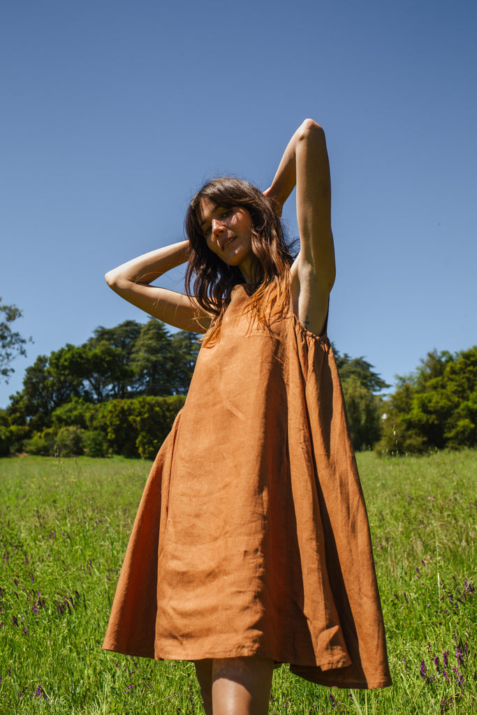 This noon dress is made in collaboration between Erica Kim and World of Crow, it has linen fabric, Brown rustic color, sleeveless, above knee-length dress, it is sustainably made and true to size