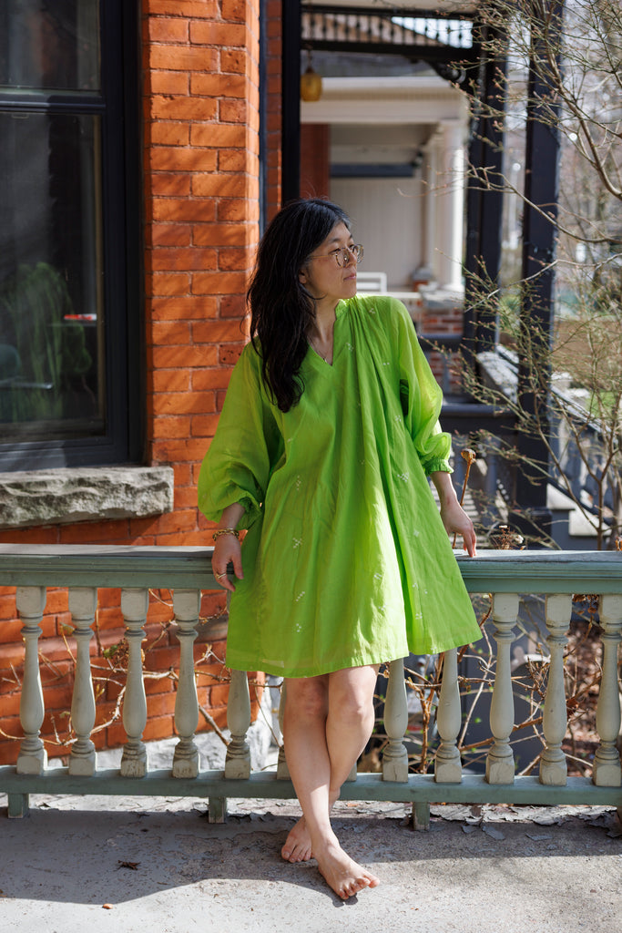 This Pride of Crow mini dress is made in collaboration between Erica Kim and World of Crow, it has a frilled round V-neckline, Sorbet green colour, A-line flare, Drop shoulders, Long gathered cuff sleeves, side pockets, Oversized fit in Jamdani fabric