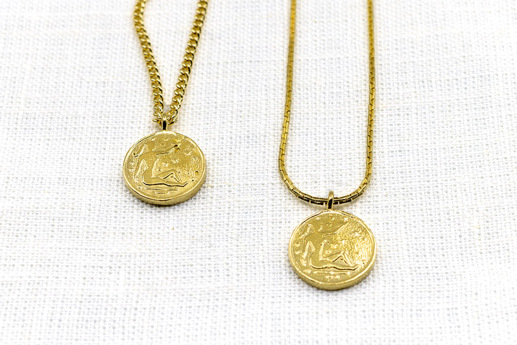 Introducing the Vintage Goddess Coin Necklace, featuring two coins on a 14K gold-plated curb chain. Made from recycled brass, this necklace combines timeless elegance with modern sustainability. Crafted in NYC and LA, it’s a luxurious yet eco-friendly addition to your collection.