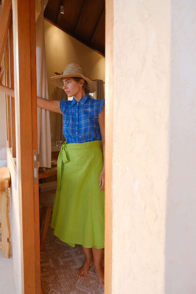 Introducing the Indigo Mary Oliver Top, a beautiful collaboration between Audrey E Leary and World of Crow. This top features a classic indigo color with jamdani checks and dot motifs, complemented by a collared neckline and ruffled detailing. Made from lightweight, soft fabric, it offers a relaxed fit and loose silhouette for everyday comfort and style.