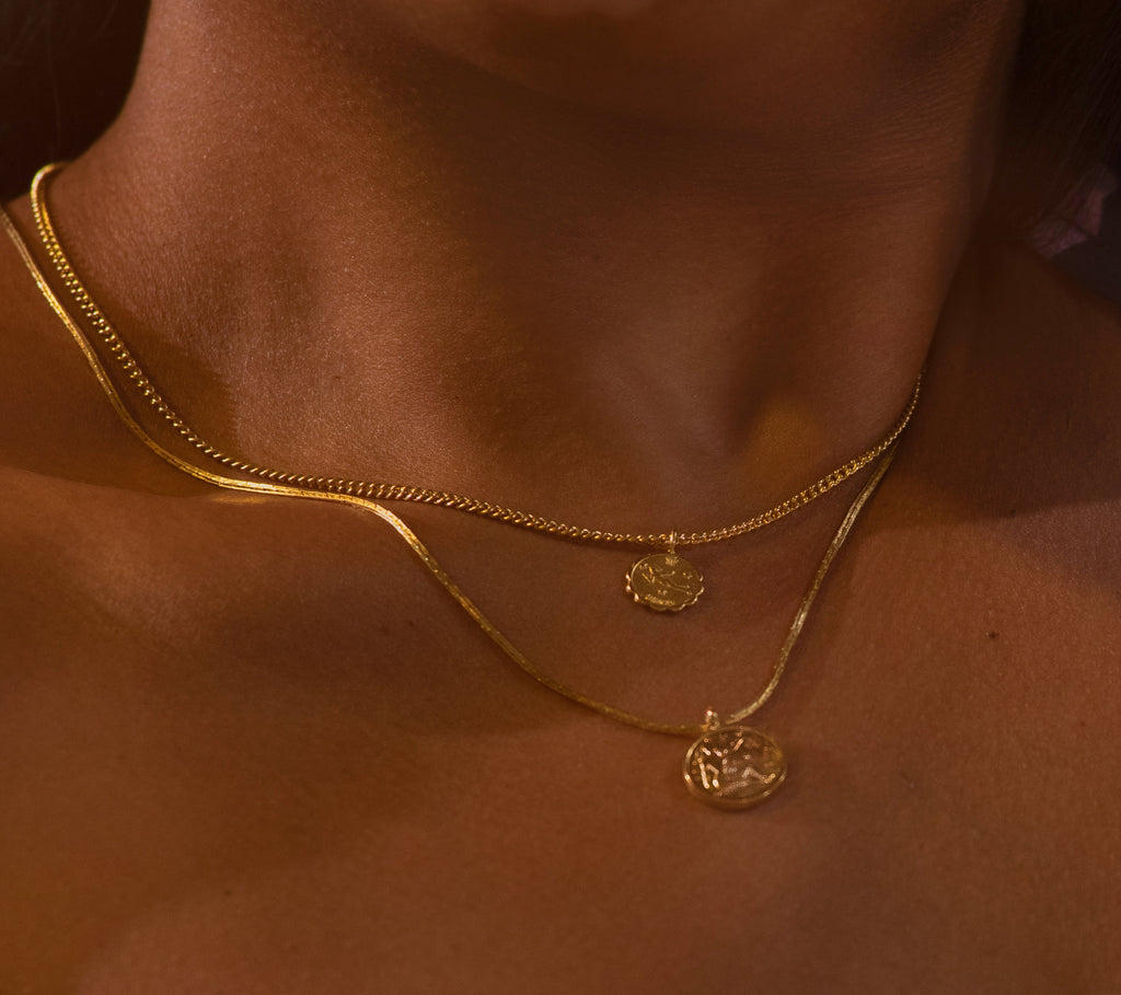 Introducing the Vintage Goddess Coin Necklace, featuring two coins on a 14K gold-plated curb chain. Made from recycled brass, this necklace combines timeless elegance with modern sustainability. Crafted in NYC and LA, it’s a luxurious yet eco-friendly addition to your collection.