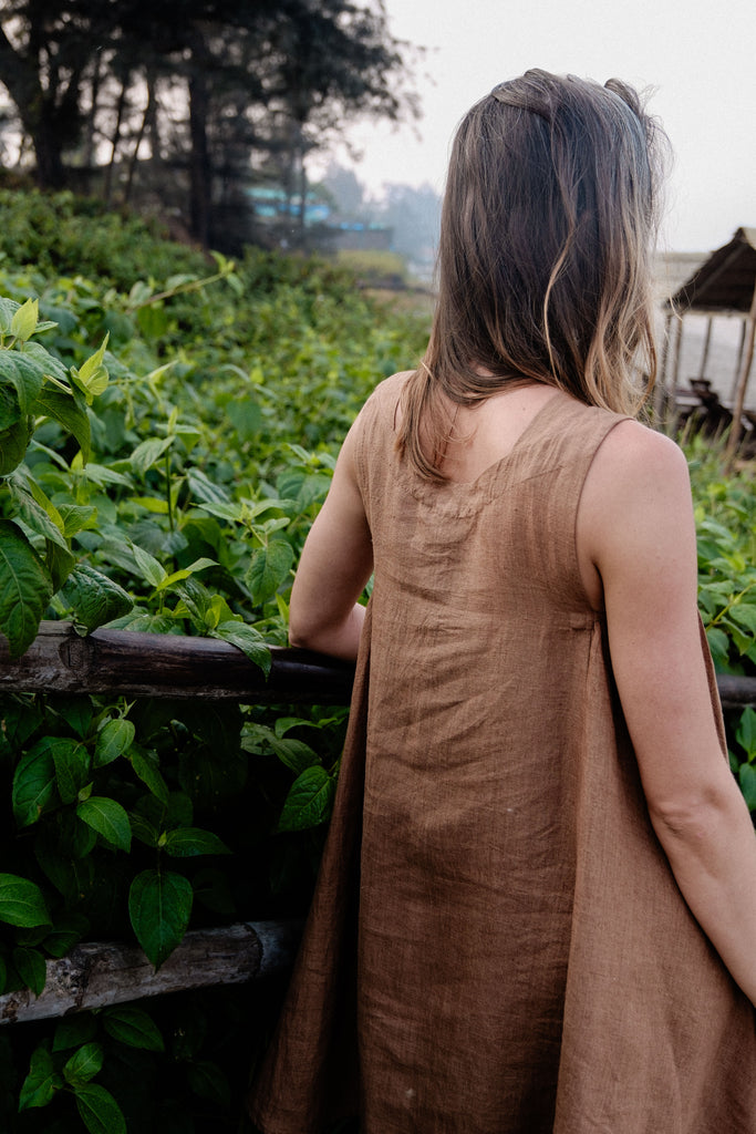 This noon dress is made in collaboration between Erica Kim and World of Crow, it has linen fabric, Brown rustic color, sleeveless, above knee-length dress, it is sustainably made and true to size