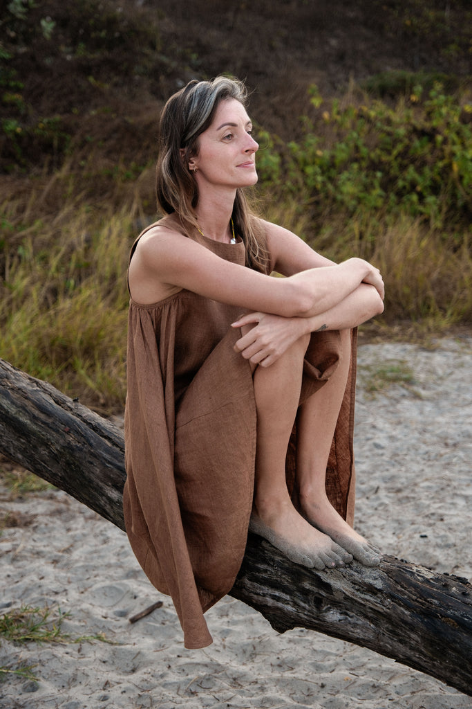 This noon dress is made in collaboration between Erica Kim and World of Crow, it has linen fabric, Brown rustic color, sleeveless, above knee-length dress, it is sustainably made and true to size