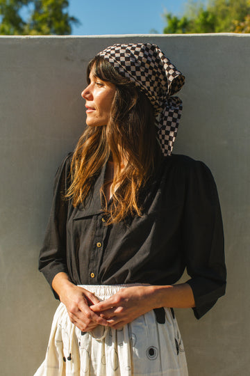 Introducing the Classic Checks Bandana, crafted from premium block-printed fabric for timeless elegance. This versatile accessory can be styled as a scarf or tied in your hair for a touch of effortless charm. Add a dash of sophistication to your look with this essential accessory.