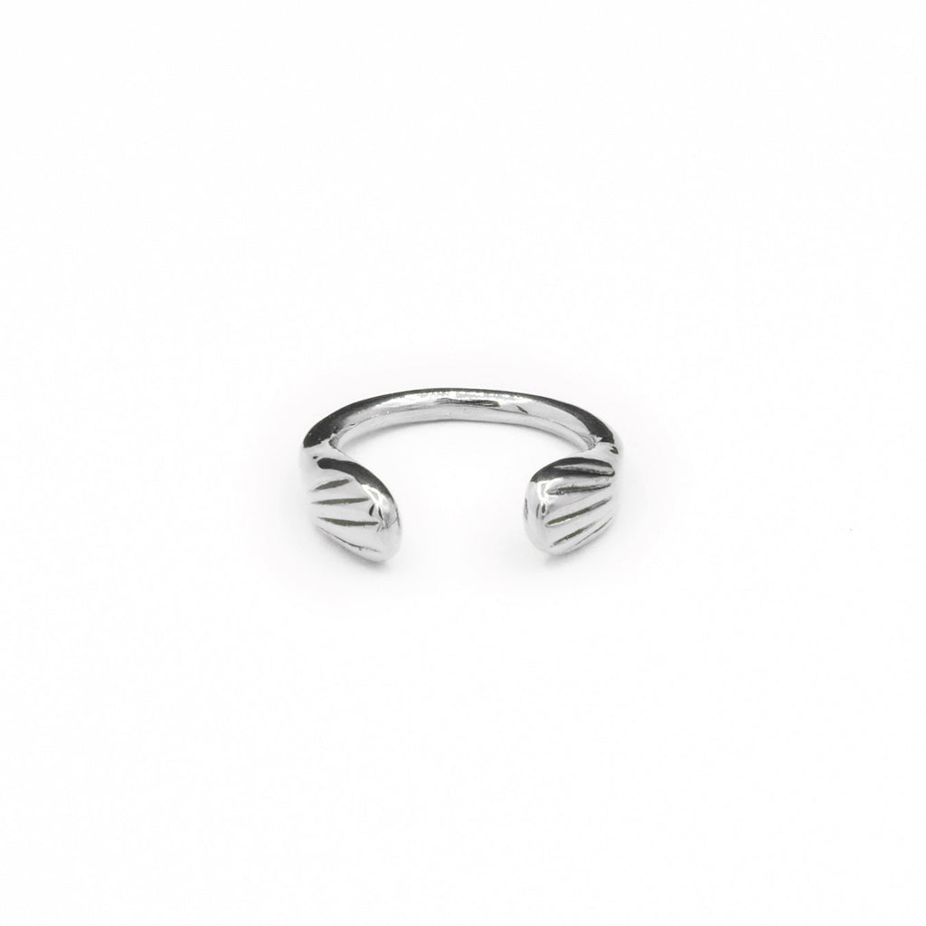 Introducing the sustainably hand-casted silver ring from the Mana Made x CCE Collection, featuring a distinctive wave design inspired by the sea. Crafted from recycled sterling silver and brass, this adjustable ring fits sizes 6 to 9, embodying a commitment to both style and environmental responsibility.