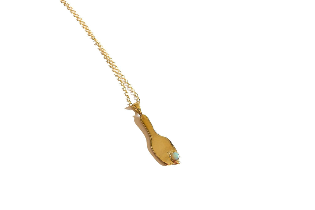 Introducing the Broken Vessel Necklace, a striking modernist design first carved in wax and cast in brass, then set with a 5mm Ethiopian Welo opal. This pendant hangs from a substantial 26" 14k gold fill chain, with the option for a customized length. Handmade in Southern California, this necklace symbolizes the beauty and light that shines through imperfections.