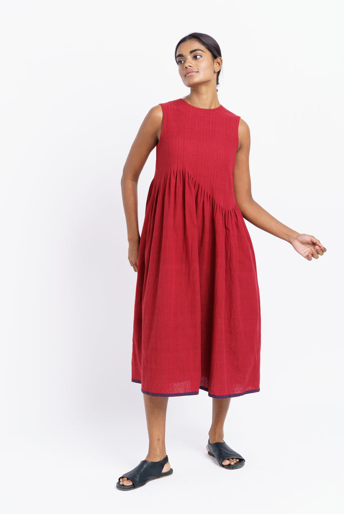 Red pleated midi dress, best ethical clothing brands India, best sustainable clothing brands, organic cotton wear, organic dresses online, cotton only clothing, cotton only clothing store, women's organic dresses, lightweight cotton women's clothing, clothing brands for minimalists, design minimalist wardrobe